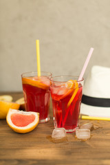 Fototapeta premium two glasses of fruit drink blackcurrant with hat on table