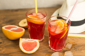 two glasses of fruit drink blackcurrant with hat on table