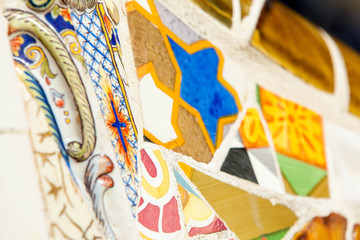 Mosaic wall at the Parc Guell designed by Antoni Gaudi located on Carmel Hill, Barcelona, Spain.