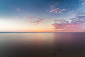 Obraz premium sunrise on the water / Early summer morning bright sky Beach