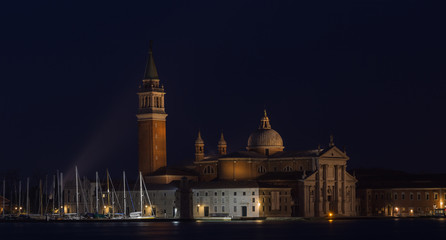 Fototapeta na wymiar VENICE, ITALY - JANUARY 2, 2016: Streetlight on the background of the Church of San Giorgio Maggiore - Venice, Italy