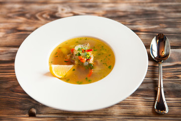 vegetable soup in white bowl on wooden rustic table. top view