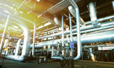 Equipment, cables and piping as found inside of a modern industr