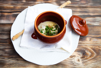 Meat Dumplings - russian pelmeni with sour cream on rustic backg