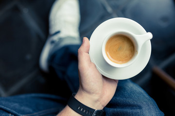a hand holding an espresso