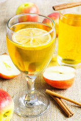 Healthy apple juice drink and red apples fruits on wooden table.