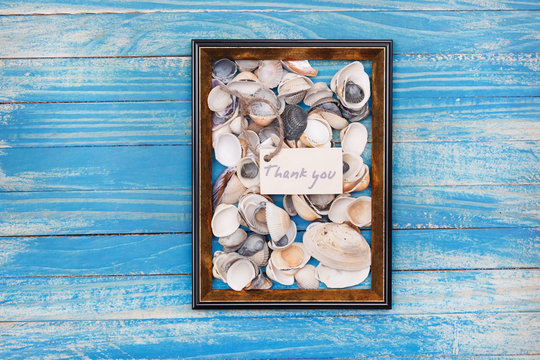 Sign Thank you with shells and photo frame. Vocation background