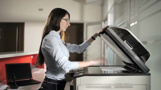 Young girl printing in the office