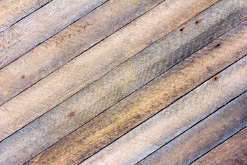 background texture old gray barn board with diagonal wooden slats. toned photo