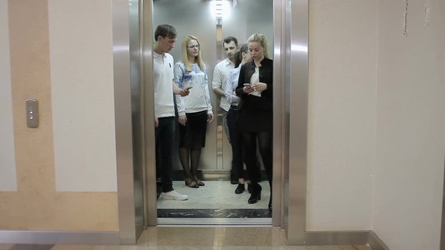 Five workers in the elevator