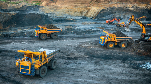 Excavators on a construction site working on coal. General construction scene
