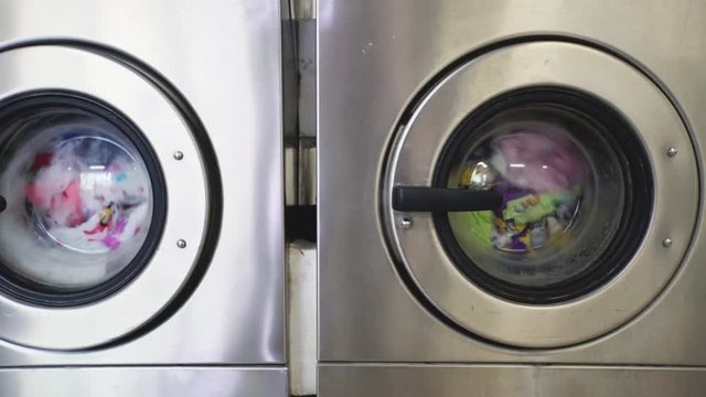 Washing machines in laundry room with rotating drums