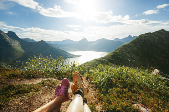 Low Section Of Hikers Sitting On Mountain During Summer