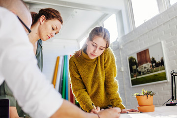 Business people working on project at table in creative office