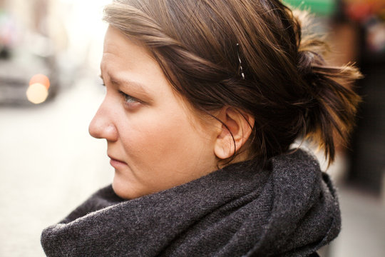 Profile of woman wearing black scarf outdoors