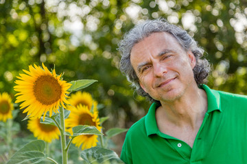 mature man near sunflowers
