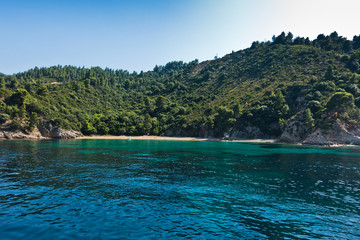 Deserted sandy beach with emerald green water at Sithonia, Greece