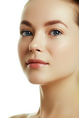 Fototapeta premium Beautiful face of a young caucasian woman. Woman beauty face portrait with healthy skin. Portrait of beautiful young woman looking at camera. Natural beauty concept