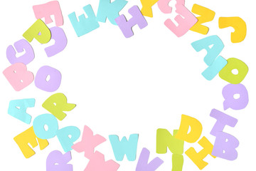 Scattered alphabet paper cut on white background