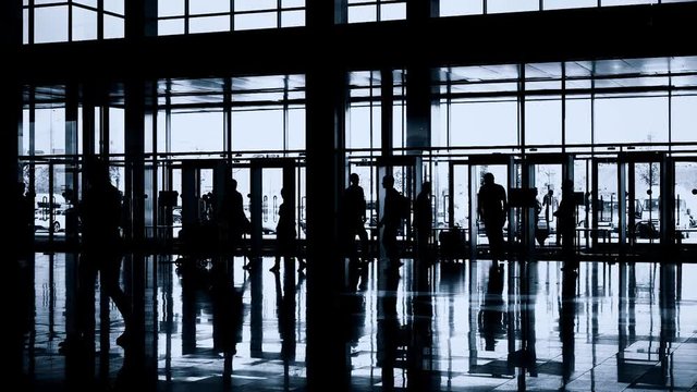 Silhouettes of people in modern lobby
