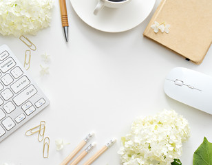 Office desk table with computer, supplies and coffee cup