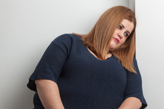 Pensive And Sad Overweight Woman