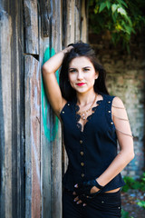 Fototapeta premium Pretty young woman near wooden wall