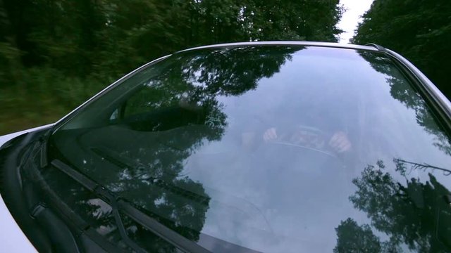 Windshield reflection. Car driving on a Country road. Trees reflected in car window. 1080p.