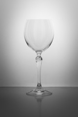empty crystal glass with long stalk isolated on gray background