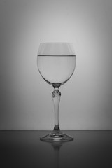 crystal glass with water isolated on gray background