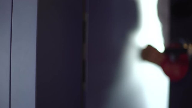 Woman in a hotel put on the door sign DO NOT DISTURB
