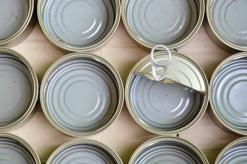 empty tin can food in brown paper box