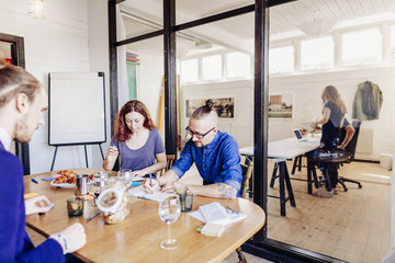 Creative business people working at table in board room