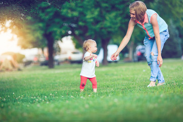 Fototapeta premium Happy family of three lying in the grass .