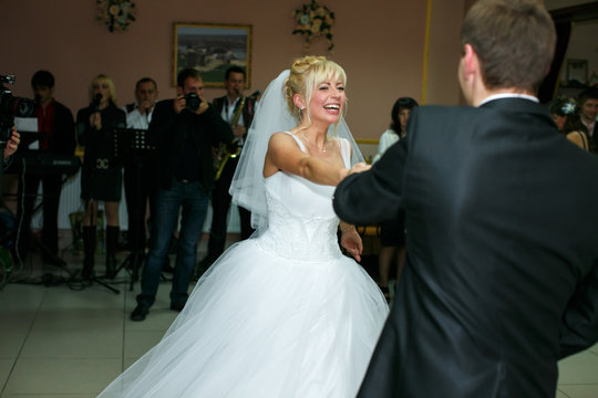 Happy bride dances her first wedding waltz