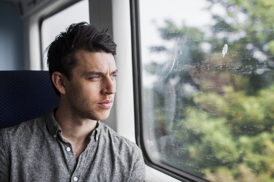 Man looking through train window