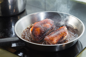 Duck fillet on grille pan. Poultry meat prepared on a grill. Fresh, delicious, spicy dish on a kitchen with copy space closeup and copy space.