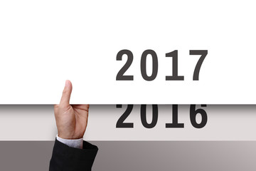 Businessman hand with banner new year 2017