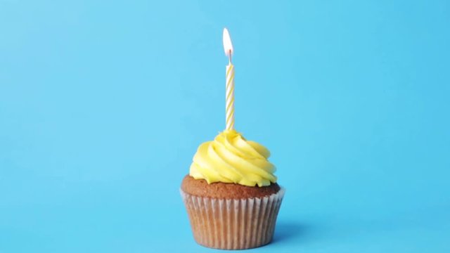 birthday cupcake with one burning candle