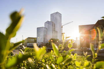 Modern buildings against sky on sunny day
