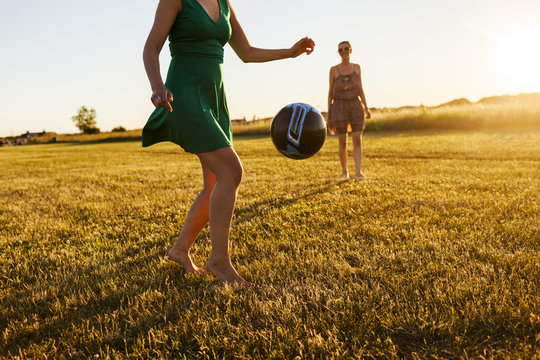 Women playing soccer in field