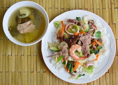 stir fried mixed vegetable with seafood on rice and pickled Chinese cabbage soup