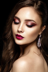 Fototapeta premium Beautiful woman portrait on black background. Young lady posing isolated with bright pink lips, gorgeous make up and hairstyle. 