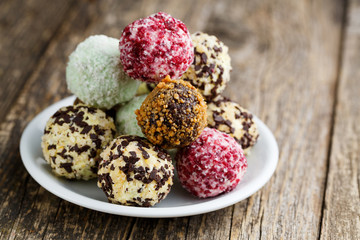 Delicious vegetarian truffle candies on wodden table.