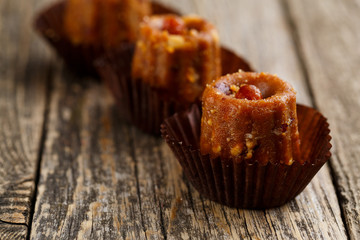 Delicious vegetarian candies anthill on wooden table for snack.