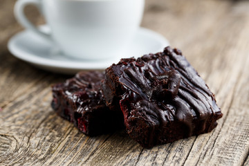 Tasty vegetarian brownie slice on wooden table for celebration.