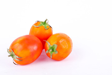 Red tomato is a vegetable that is a major component in making tomato sauce on the white background isolated
