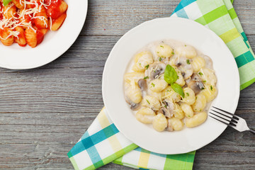 Portion of gnocchi with mushroom sauce and cheese.