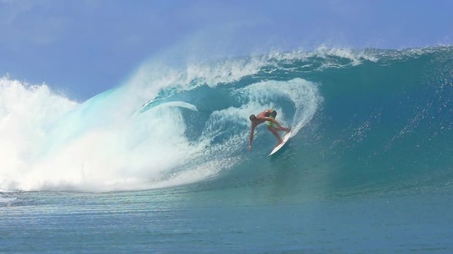 SLOW MOTION: Extreme surfer surfing inside big tube barrel wave