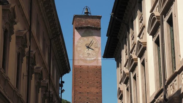 Majestic clock tower between eclectic palaces in Pavia, Italy
